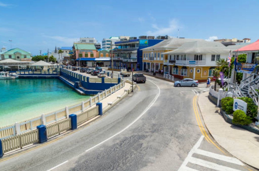 Colourful George Town Grand Cayman waterfront street with turquoise harbour, colonial buildings and National Museum near the cruise port